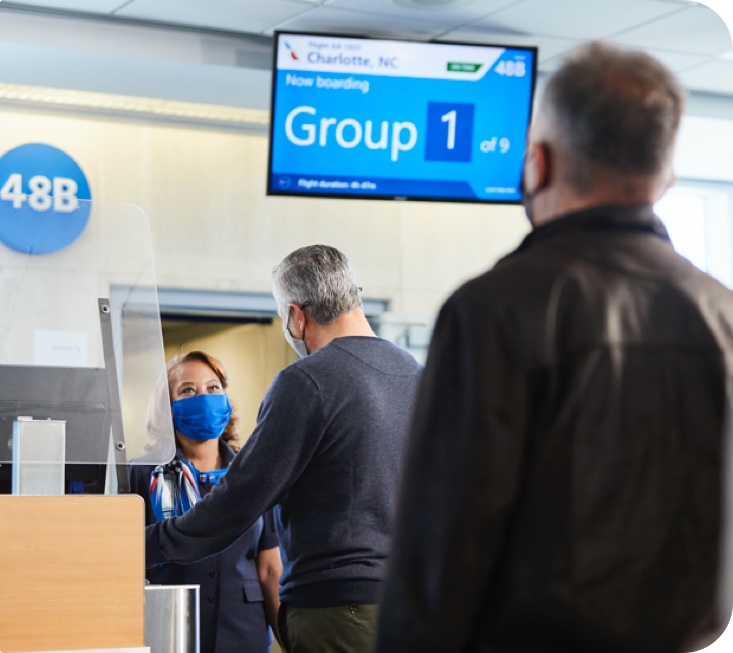 Passengers boarding Group 1 at the gate