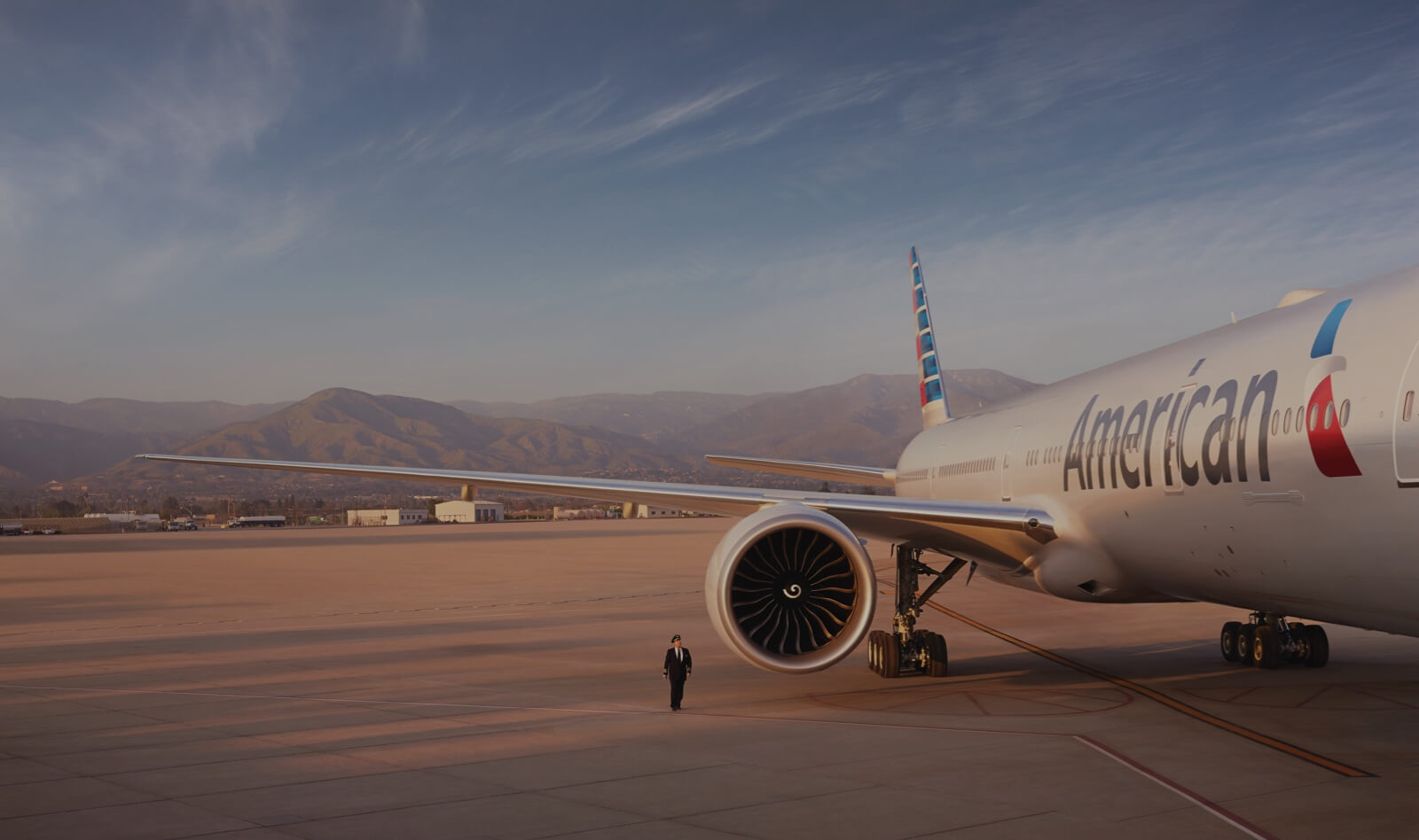 A pilot inspects an American Airlines plane on the tarmac